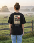 Not Lost. Found. Flyer tee in a misty pasture, back view