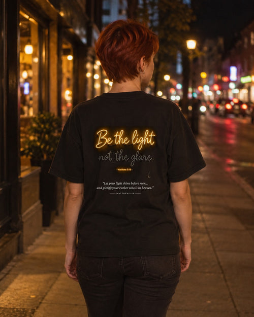 Be the Light Neon tee on a city street at night, back view