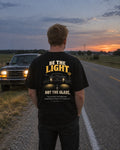 Be the Light High Beams tee on a country road, back view