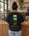 Paid in Full Card Terminal tee in a coffee shop, back view