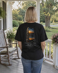 My Grandma Prayed for This Phone tee on a porch, back view