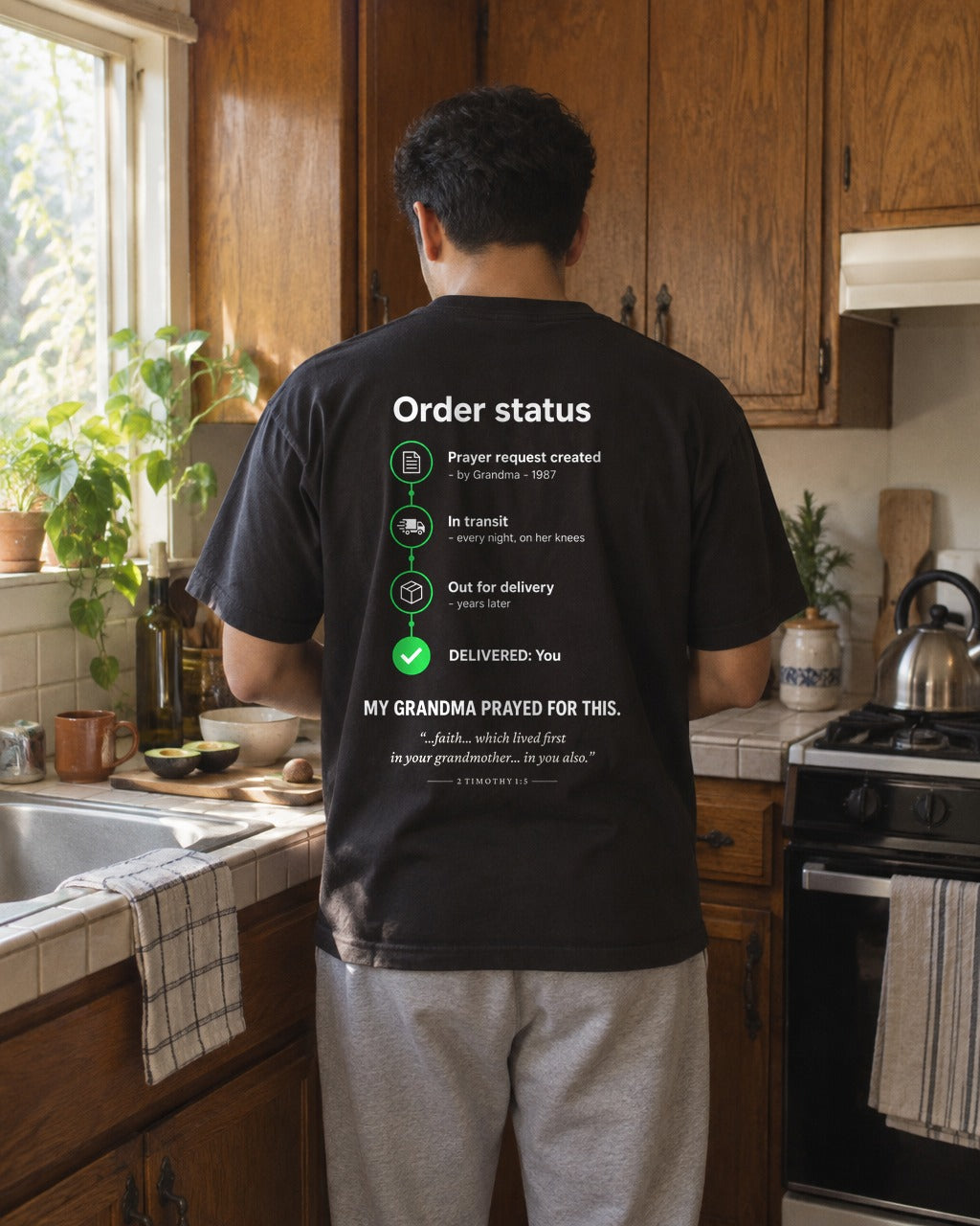 My Grandma Prayed for This Order Status tee in a kitchen, back view